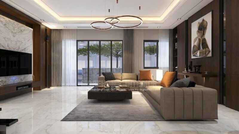 Mẫu bố trí nội thất phòng khách biệt thự đẹp sang trọng cao cấp nổi bật với chất liệu gỗ công nghiệp An Cường, bộ sofa góc nâu cùng chiếc bàn khối vuông lạ mắt.